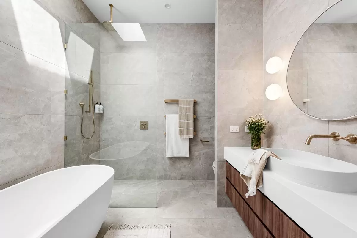 Contemporary bathroom design in Sydney featuring walk-in shower with skylight and brass tapware